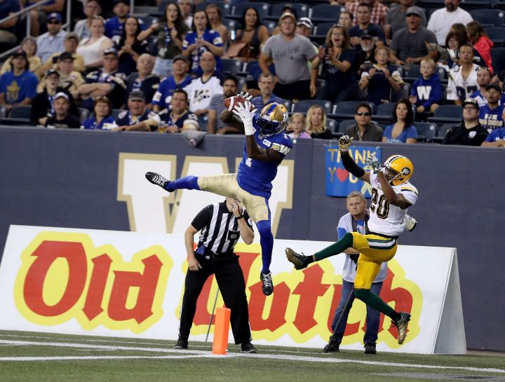 Winnipeg Blue Bombers’ Darvin Adams (1) catches a touchdown pass in front of Edmonton Eskimos Johnny Adams (20) during the first half of CFL football action in Winnipeg, Thursday, August 17, 2017.