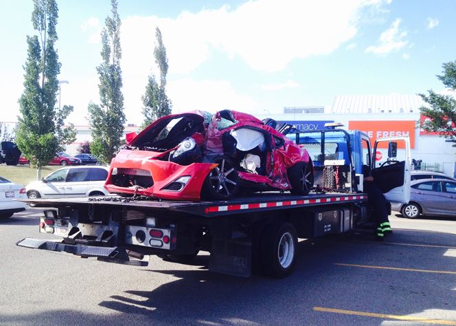 One of the vehicles involved in a fatal crash in southeast Calgary Wednesday afternoon is seen being towed away from the scene.