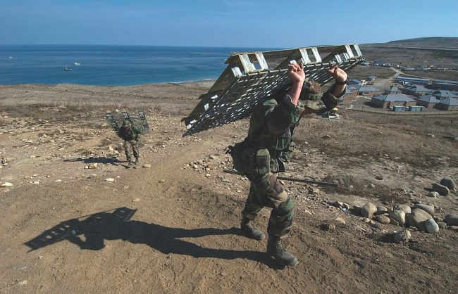 U.S. Navy SEAL trainees put through a pallet lugging training run.