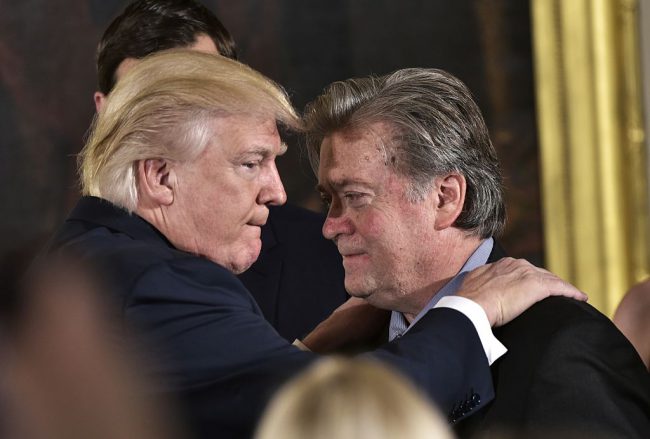 US President Donald Trump embraces Stephen Bannon during the swearing-in of senior staff in the East Room of the White House, Jan. 22, 2017 in Washington, DC. 



