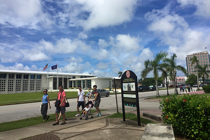 People walk around Hagatna, Guam Wednesday, Aug. 9, 2017.