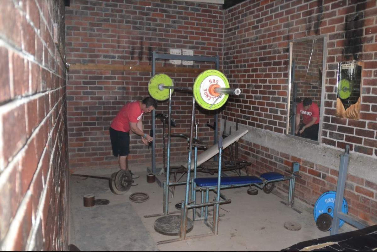 Powerlifting gym in Harare, Zimbabwe. No lights and homemade equipment.