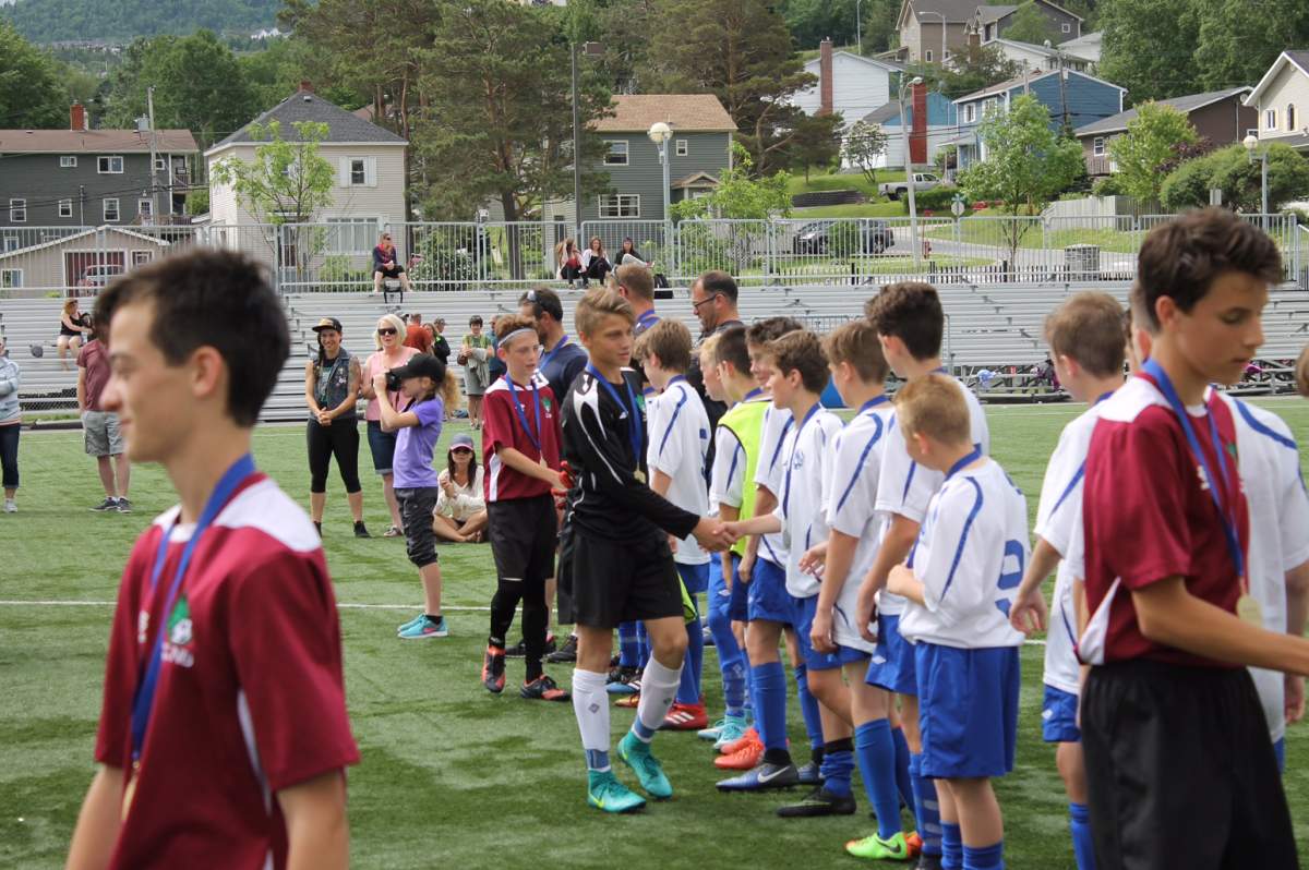 Phoenix Roberts, centre, shakes hands with an opposing team after a game at the U13 Atlantic Soccer Championships.