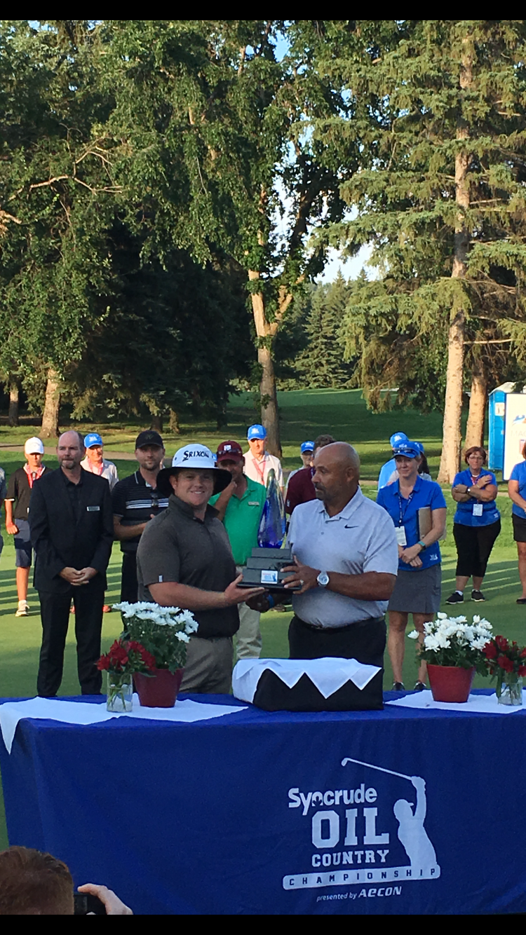 Patrick Newcomb with Oilers legend Grant Fuhr after winning the Oil Country Championship.