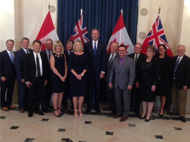 Premier Brian Pallister stands with his new cabinet after shuffle. 