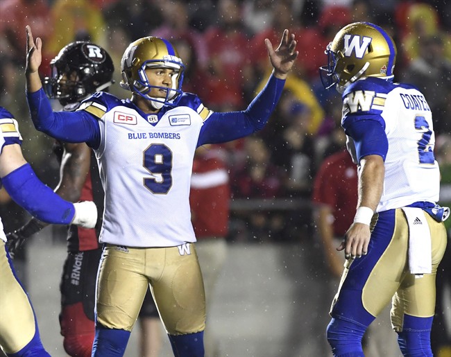 Winnipeg Blue Bombers kicker Justin Medlock (9) raises his hands as he celebrates his game winning field goal against the Ottawa Redblacks with teammate Matt Coates (2) during second half of a CFL football game in Ottawa on Friday, Aug. 4, 2017.