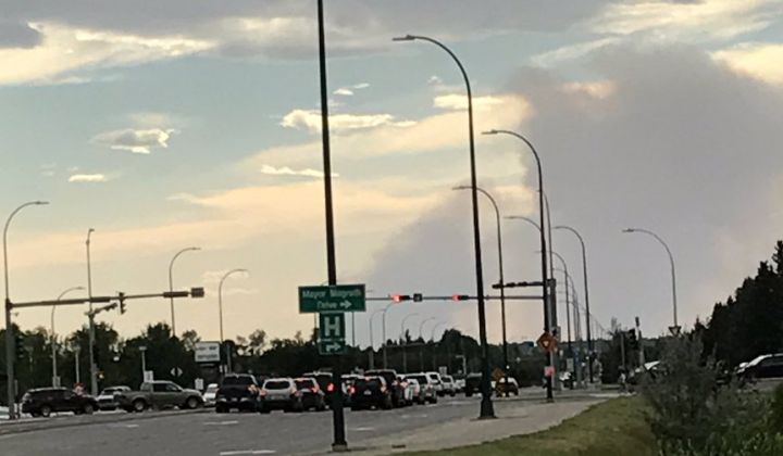 Clouds of smoke seen from Lethbridge late Friday afternoon appears to be coming from a grass fire burning at least 50 kilometres west of the city.