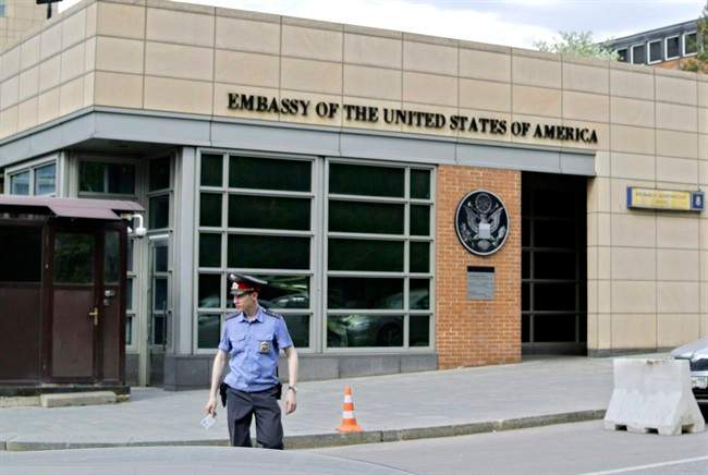 In this Tuesday, May 14, 2013 file photo, a Russian policeman stands in front of an entrance of the U.S. Embassy in downtown Moscow, Russia. 