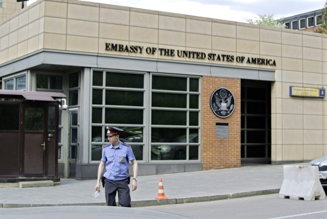 In this Tuesday, May 14, 2013 file photo, a Russian policeman stands in front of an entrance of the U.S. Embassy in downtown Moscow, Russia. 