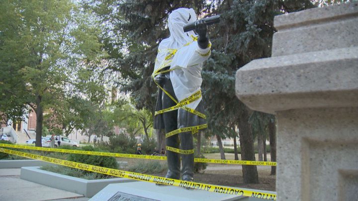Protesters covered the statue of John A. Macdonald in Victoria Park this week with plastic wrap and caution tape.