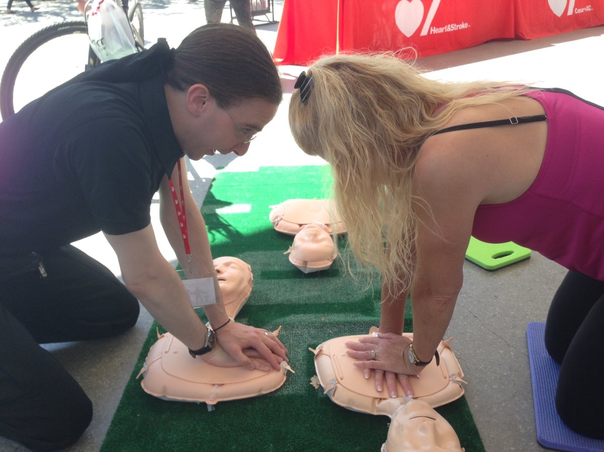 People learn how to give hands-only CPR during free training at the Forks Sunday. 