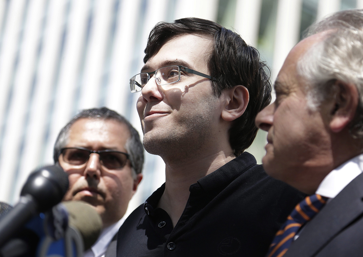 Martin Shkreli, center, stops with his attorneys to talk to reporters in front of federal court in New York, Friday, Aug. 4, 2017.