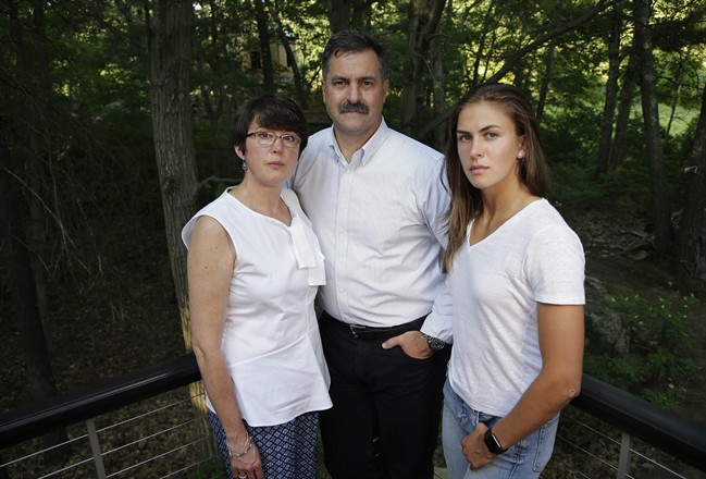  In this Wednesday, Aug. 9, 2017 photo family members of 18-year-old murder victim Andrew Oneschuk, from the left, mother Chris, father Walter, and sister Emily, stand for a portrait at their home in Wakefield, Mass. 
