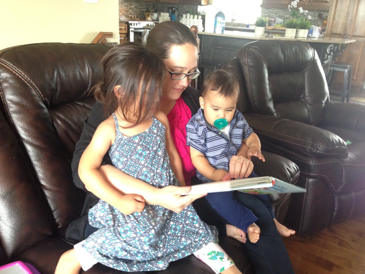 Monica Larocque reads a story to her daughter Matilda and one-year-old son Mateo at their Oromocto, N.B., home. 