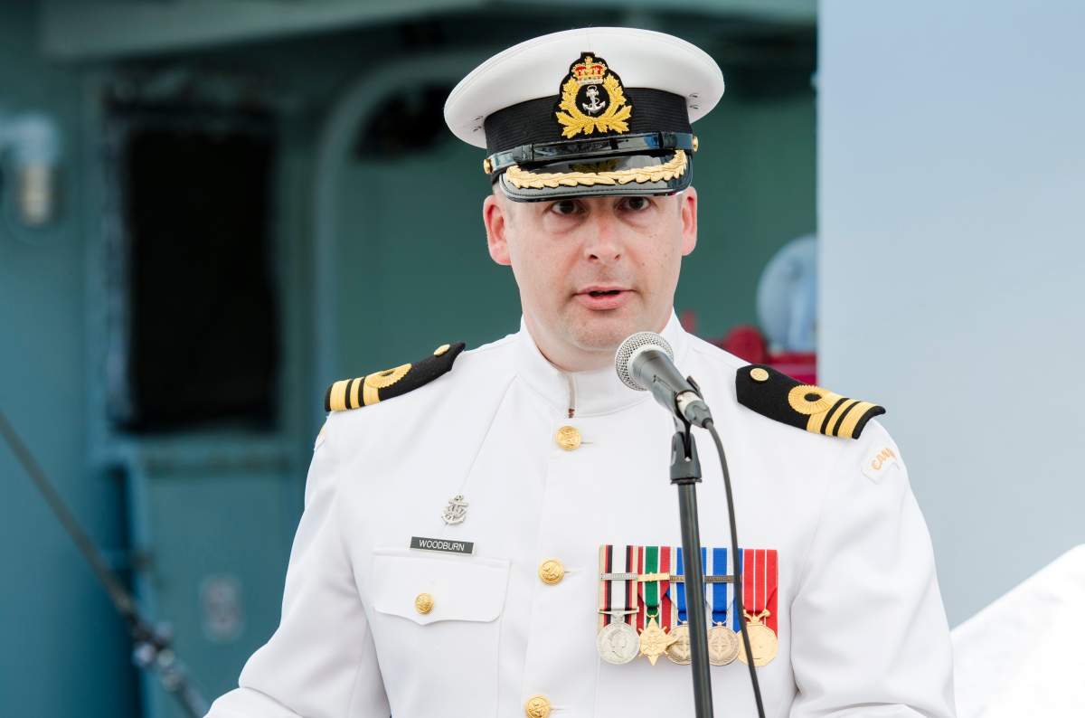 LCdr Matt Woodburn addresses the crew and guests on-board HMCS Kingston.