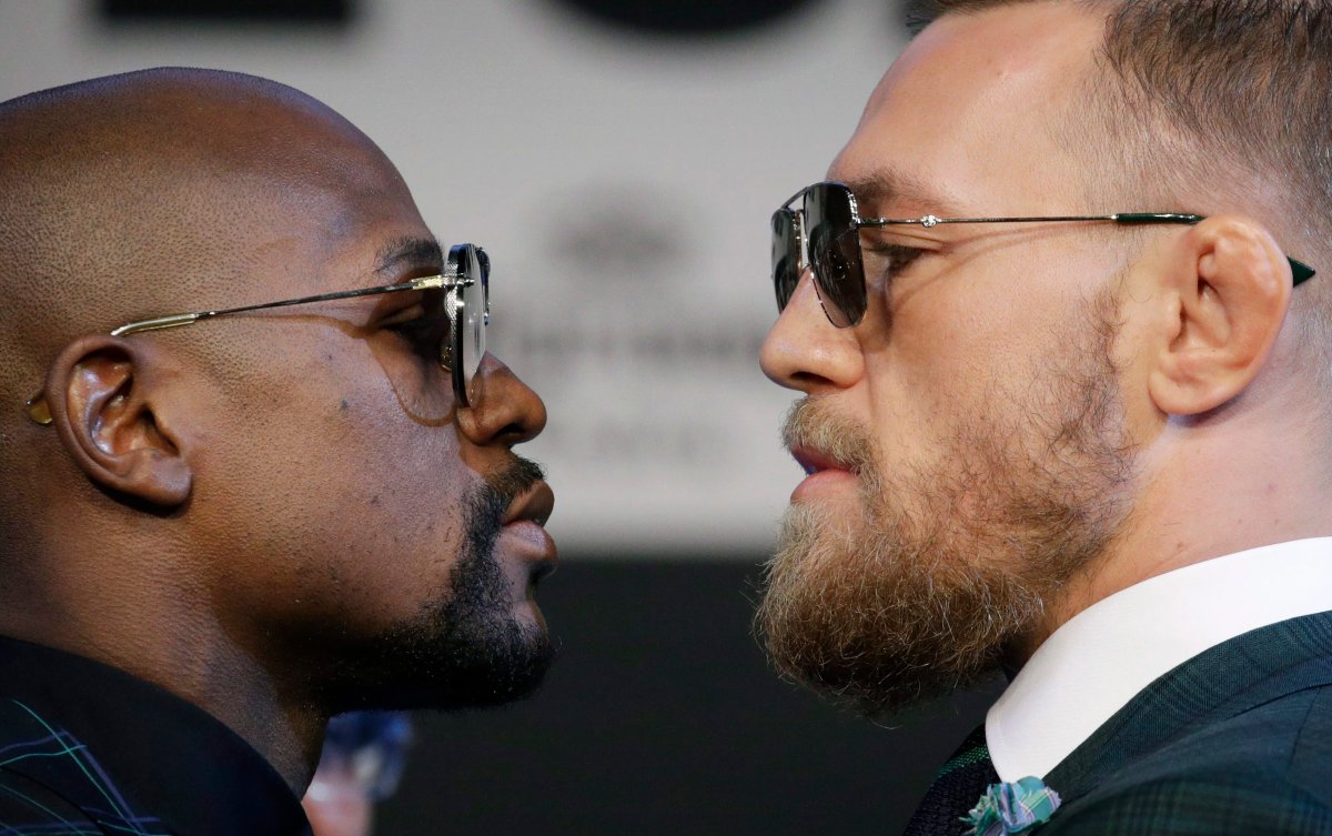 Floyd Mayweather Jr., left, and Conor McGregor pose for photographers during a news conference Wednesday, Aug. 23, 2017, in Las Vegas. The two are scheduled to fight in a boxing match Saturday in Las Vegas. 