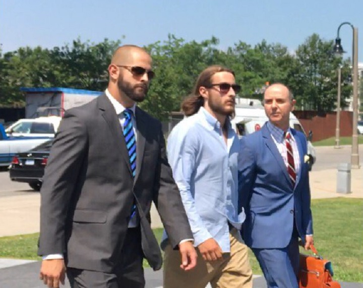 Const. Michael Theriault, (left), and Christian Theriault, (centre), arrive in court in Oshawa, Ont., on Aug. 2, 2017.