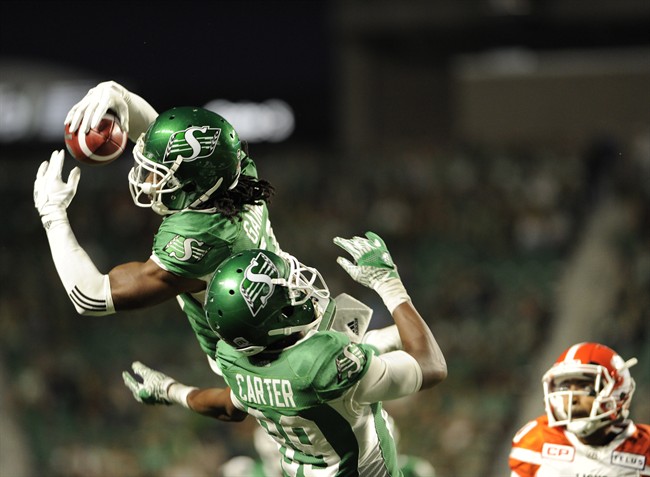 Saskatchewan Roughriders defensive back Ed Gainey outleaps teammate Duron Carter to record his fourth interception during second half CFL action against the B.C. Lions, in Regina on Sunday, August 13, 2017. Gainey and quarterback Kevin Glenn and Edmonton quarterback Mike Reilly are the CFL's top performers for Week 8.
