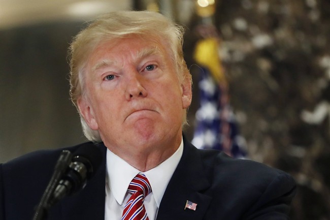 President Donald Trump listens to a question while meeting the media in the lobby of Trump Tower in New York, Tuesday, Aug. 15, 2017.