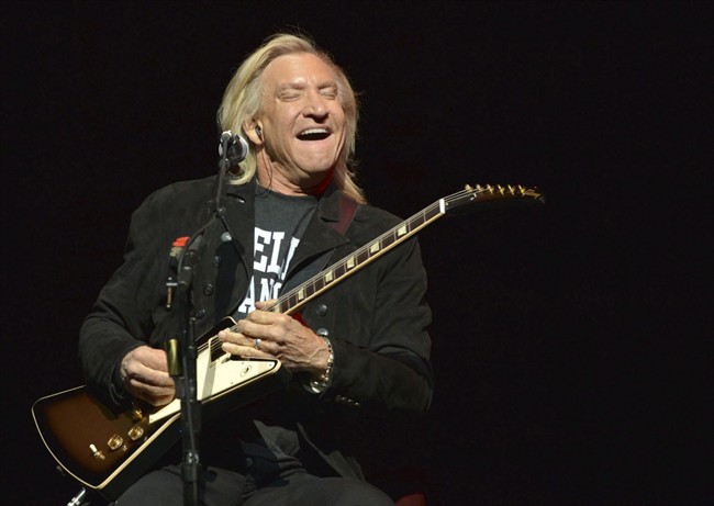 In this Jan. 15, 2014, file photo, Joe Walsh of The Eagles performs on the “History of the Eagles” tour at the Forum in Inglewood, California.