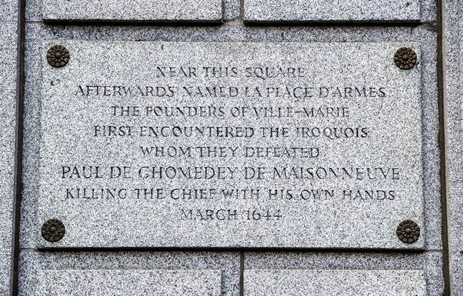 A plaque is seen on the Bank of Montreal building, Thursday, August 3, 2017 in Montreal. Michael Rice, a Mohawk man, wants the Bank of Montreal and the City of Montreal to address a plaque attached to the bank's headquarters downtown that was written in honour of Paul de Chomedey, sieur de Maisonneuve, the founder of Montreal as the plaque is historically inaccurate.