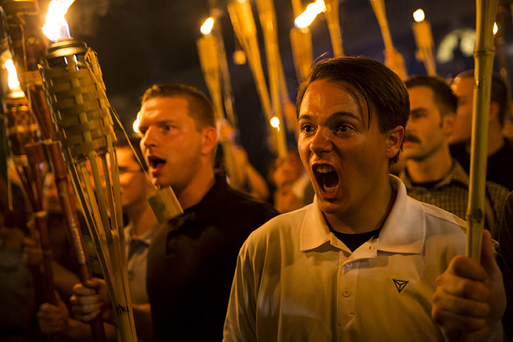 White nationalists encircle and chant at counter protestors at the base of a statue of Thomas Jefferson after marching through the University of Virginia campus with torches in Charlottesville, Va., on August 11, 2017.