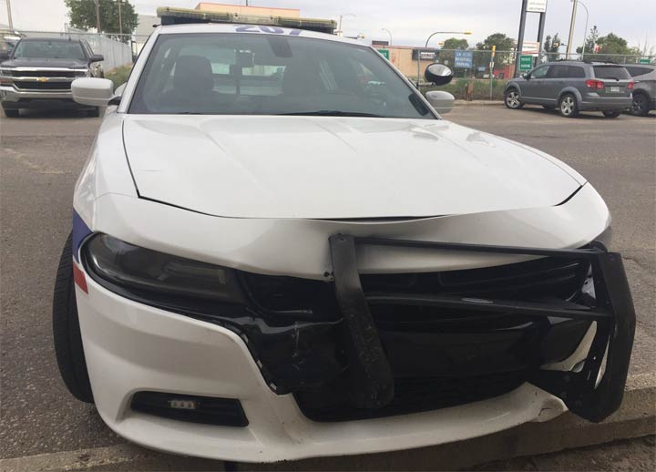 Police say one of their cars was rammed by a vehicle stolen from a couple of Good Samaritans in Prince Albert, Sask.
