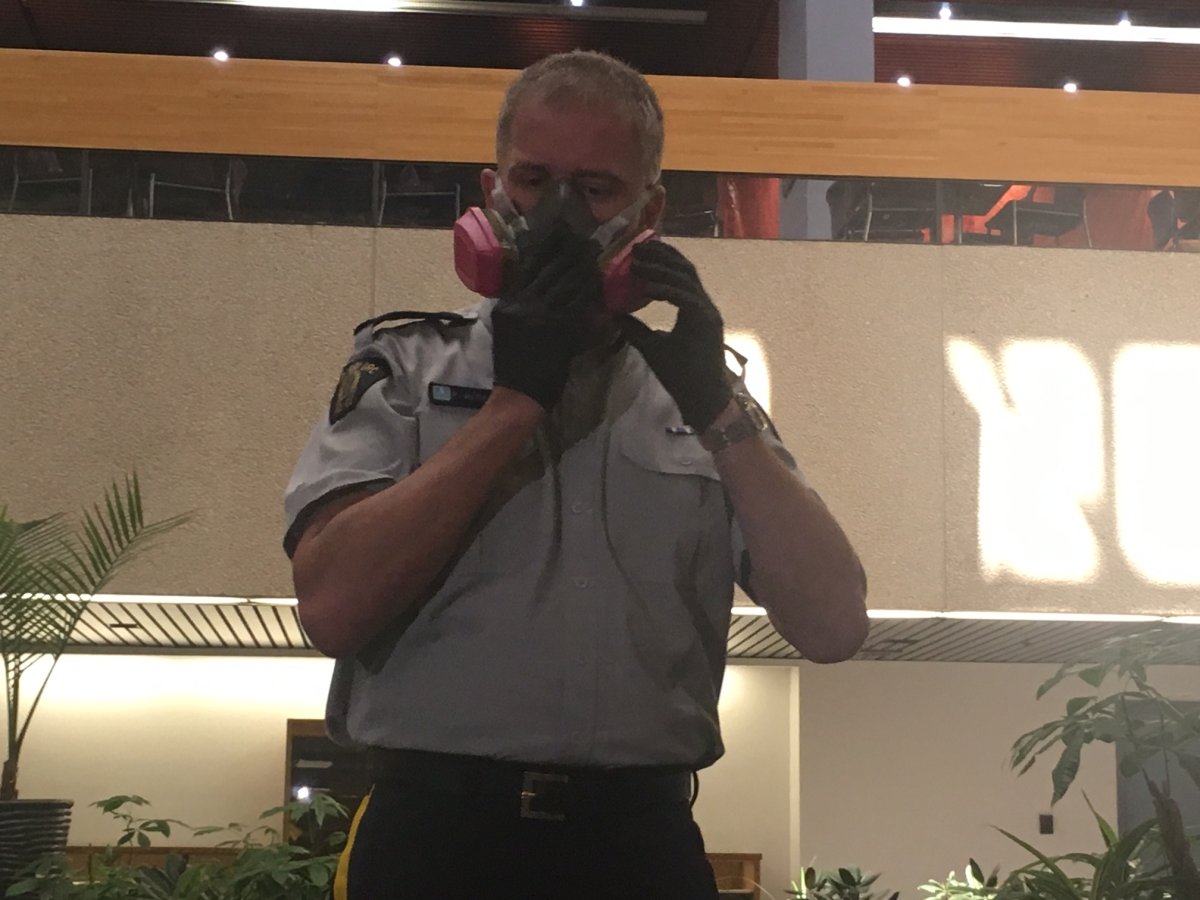 RCMP officer demonstrates new fentanyl protective gear Friday. 