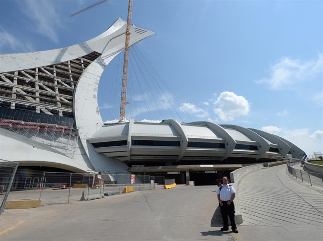 A security guard stands outside Olympic Stadium in Montreal, Wednesday, Aug. 2, 2017.