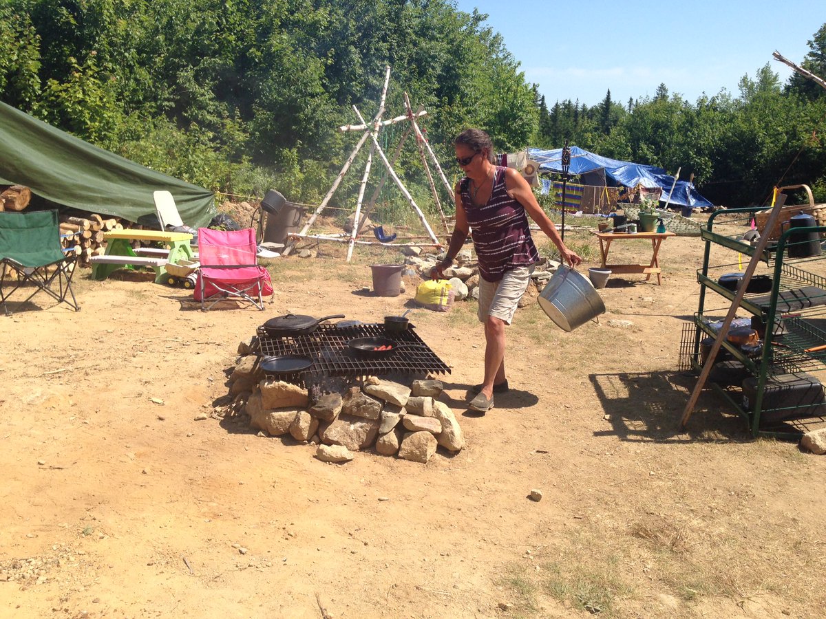 Terry Sappier boilers water and prepares to make lunch where she's living at the proposed tailings pond site for the Sisson Mine.