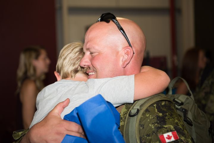 Master Warrant Officer Clay Shoepp a member of 3rd Princess Patricia’s Canadian Light Infantry hugs his son upon returning from OPERATION REASSURRANCE,