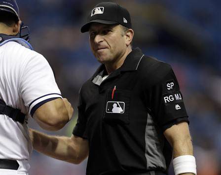 Home plate umpire Chris Guccione talks to Tampa Bay Rays catcher Wilson Ramos during the first inning of a baseball game between the Rays and the Seattle Mariners Saturday, Aug. 19, 2017, in St. Petersburg, Fla. The World Umpires Association, the union representing Major League Baseball umpires announced that umpires will be wearing white wristbands during all games to protest the escalating verbal attacks on umpires and their strong objection to the Office of the Commissioner's response to the verbal attacks.