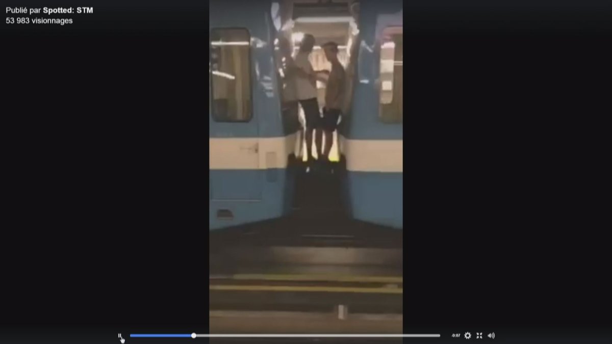 Frame grab of a video which appears to show two men riding between two metro cars.  (Facebook/Spotted: STM).