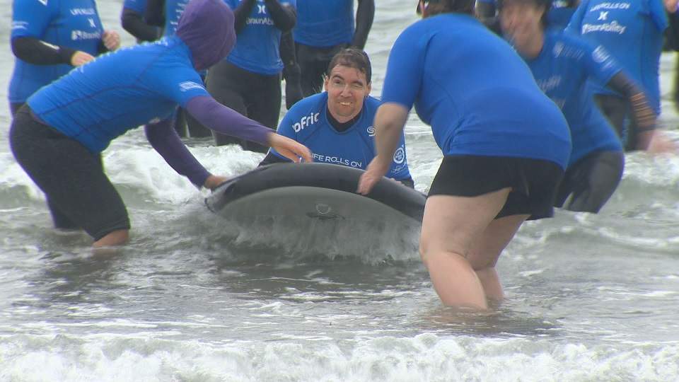 People with disabilities learn how to surf through annual event ...