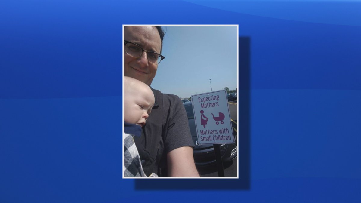 Justin Simard and his nine-month-old son Charles are seen in this undated handout photo in Stratford, P.E.I. A father who miffed at a parking spot for new mothers at a P.E.I. grocery store has successfully prodded Sobeys to change its policy so that new dads are included too.