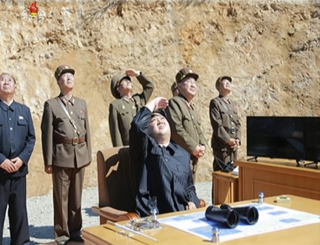 This file image made from video of a news bulletin aired by North Korea's KRT on July 4, 2017, shows what was said to be North Korea leader Kim Jung Un, center, watching the launch of a Hwasong-14 intercontinental ballistic missile, ICBM, in North Korea's northwest. 