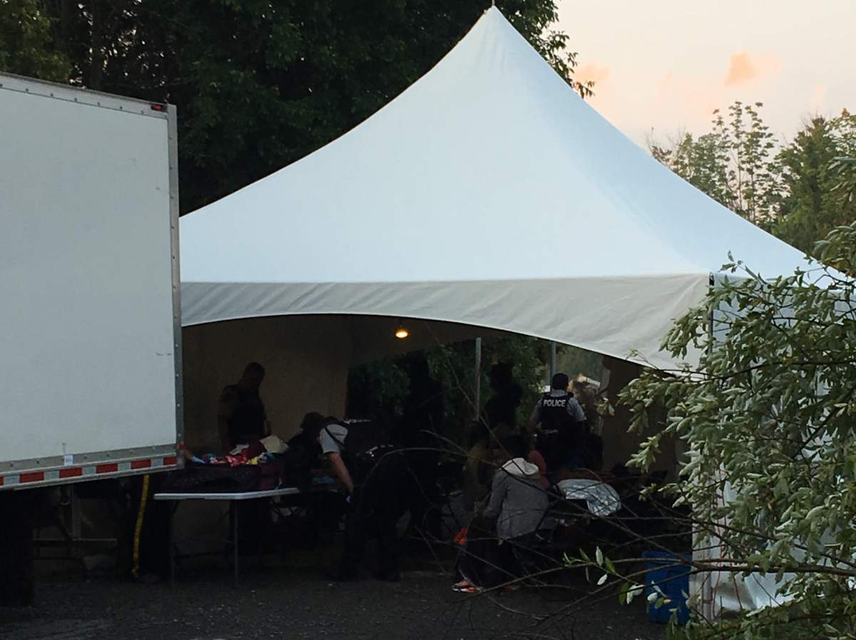 RCMP officers process asylum seekers at a Canada-U.S. border crossing in Lacolle, Thursday, August 3, 2017.