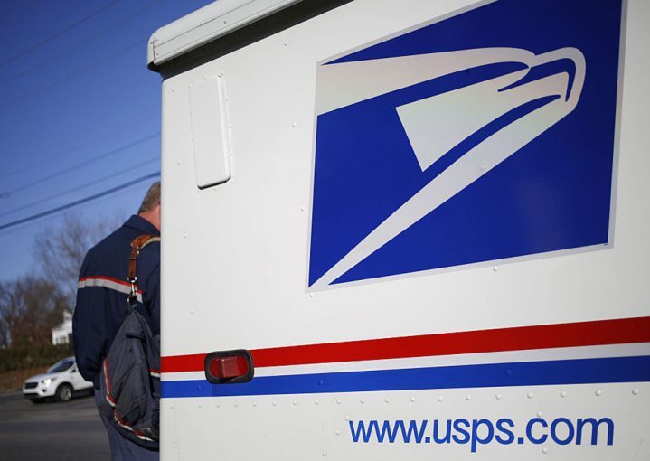 A United States Postal Service (USPS) letter carrier delivers mail.