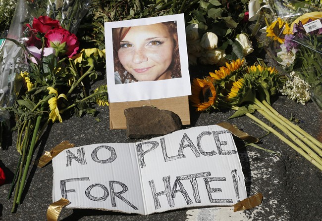 A makeshift memorial of flowers and a photo of victim, Heather Heyer, sits in Charlottesville, Va.