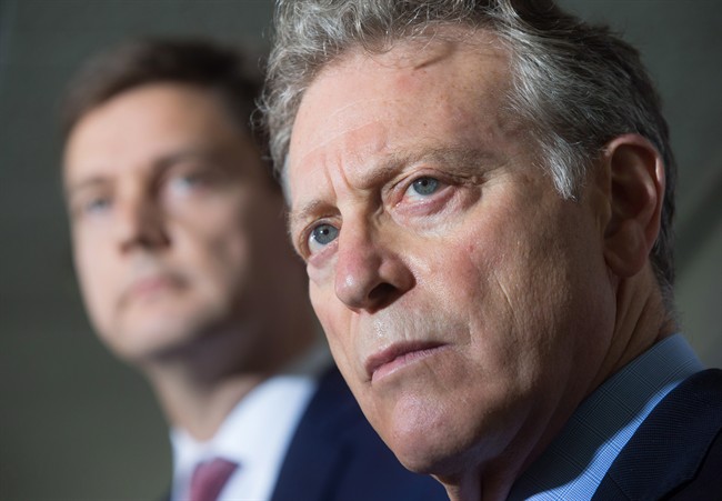 B.C. Environment Minister George Heyman, front, and Attorney General David Eby listen to a question during a news conference about the Kinder Morgan Trans Mountain pipeline expansion project, in Vancouver, B.C., on Thursday August 10, 2017.