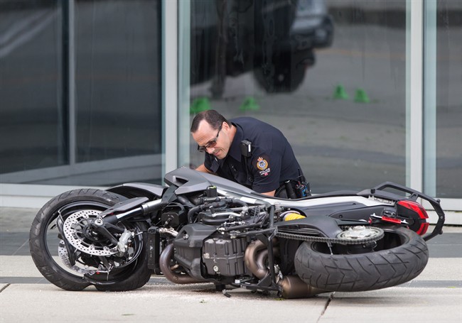 A police officer examines a motorcycle after a female stunt driver working on the movie "Deadpool 2" died after a crash on set, in Vancouver, B.C., on Monday August 14, 2017. 