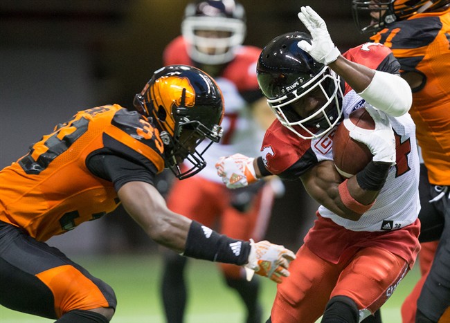 Calgary Stampeders' Roy Finch, right, tries to avoid the tackle by B.C. Lions' Chandler Fenner while returning a kick during the first half of a CFL football game in Vancouver, B.C., on Friday August 18, 2017. 