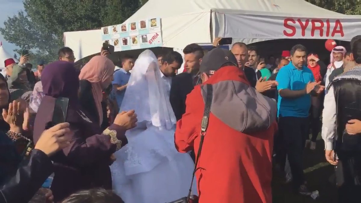 A Syrian couple exchanges vows at the Servus Heritage Festival Saturday.