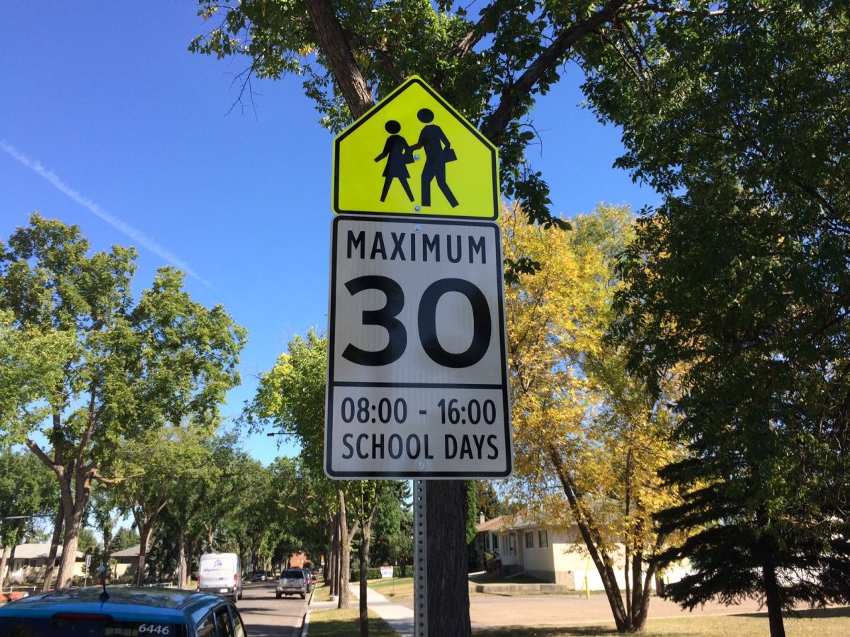 School zone speed limit signs read 8 - 4 p.m. outside St. Mark's Junior High School in Edmonton near 116 Avenue and 135 Street. Sept. 4, 2017. 