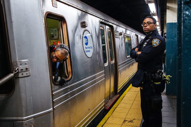 A New York City Police Department officer stands in front of a subway train in New York City, USA, November 7, 2016.