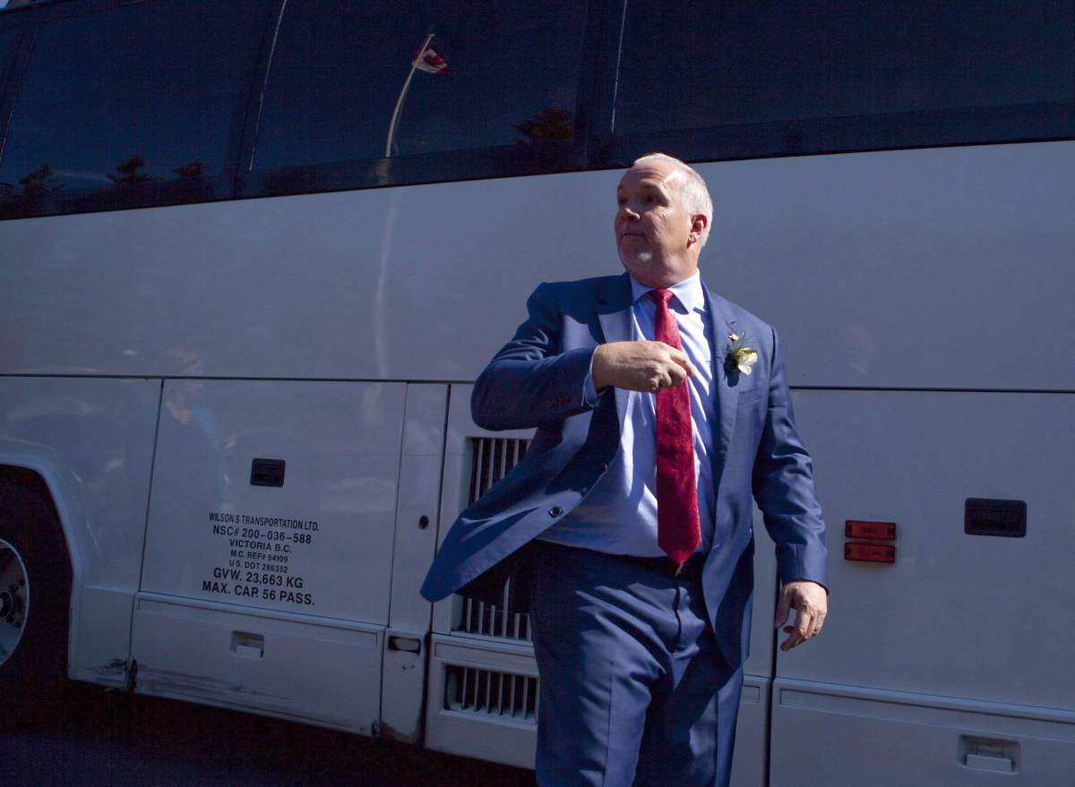 Premier John Horgan adjusts his tie as he leaves Government House after being sworn-in as Premier in Victoria, B.C., on Tuesday, July 18, 2017.