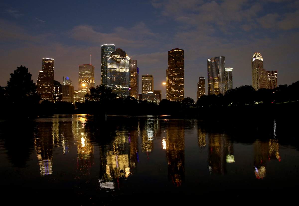 Downtown Houston, Texas is reflected in flooded Buffalo Bayou Wednesday, Aug. 30, 2017, as the city continues to recover from record flooding caused by Hurricane Harvey.