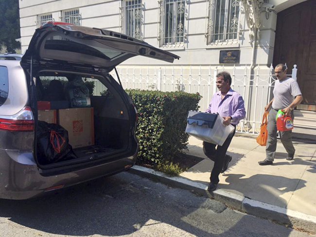 Workers carry boxes out of the Russian consulate in San Francisco, Sept. 1, 2017.