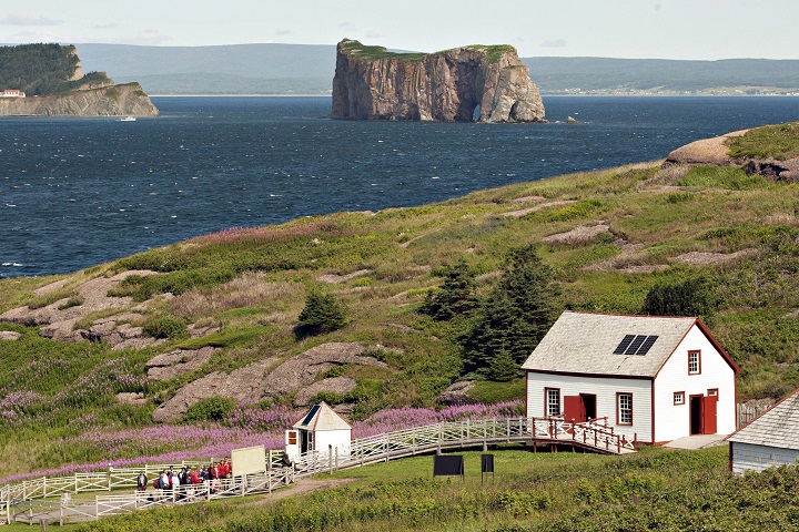 The Bonaventure Island is shown overlooking the Perce rock on July 25, 2012. The windswept archipelago of Iles-de-la-Madeleine used to spend most of every winter firmly encased in the ice of the Gulf of St. Lawrence, protected from the worst effects of winter storms. But warmer temperatures in recent years mean the surrounding waters are more often ice-free, leaving the eastern Quebec island chain at the mercy of battering waves that eat away at the coastline and put vital infrastructure at risk. 