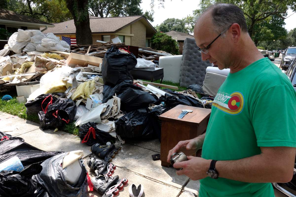 In this Sept. 4, 2017 photo, James Kennedy surveys the damage from Hurricane Harvey to his house in Houston. Kennedy, who towed his wife and three kids to safety on an inflatable mattress, had been working 14-hour days since the flood hit and bemoaned the loss of keepsakes like baby photos that can’t be replaced or Grateful Dead albums, cassettes and ticket stub from 103 concerts.